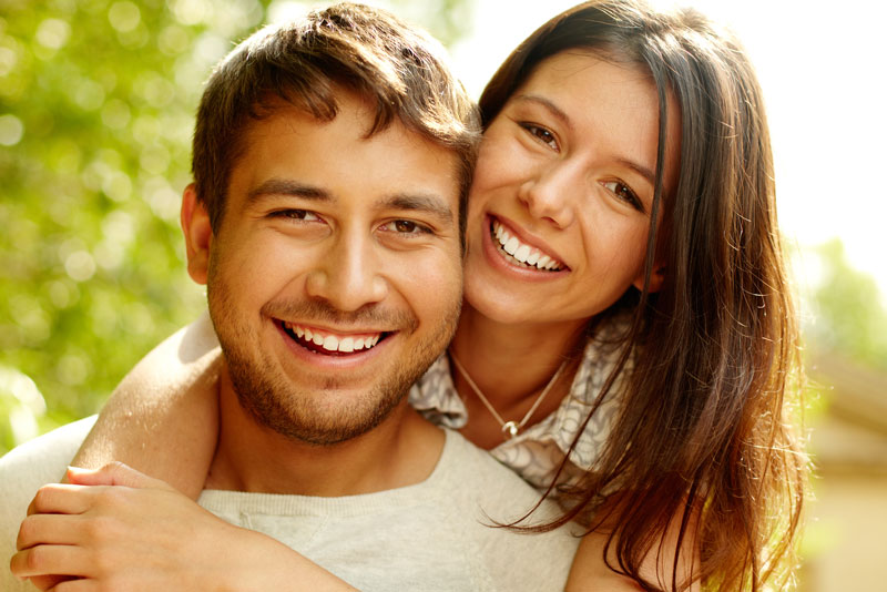 Dental Patients Smiling With Well Cared For Dental Implants In [location 2]