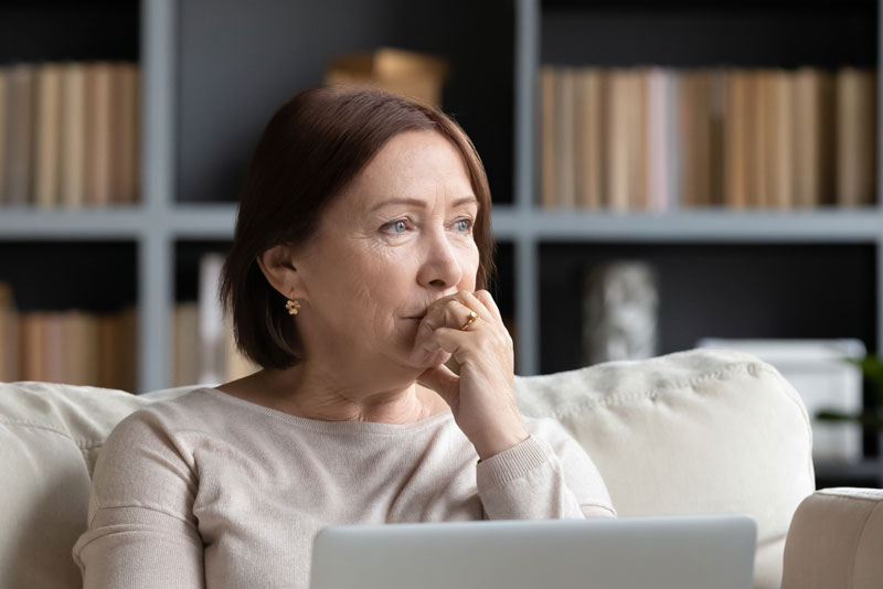 dental patient deciding on whether to get dental implants or dentures