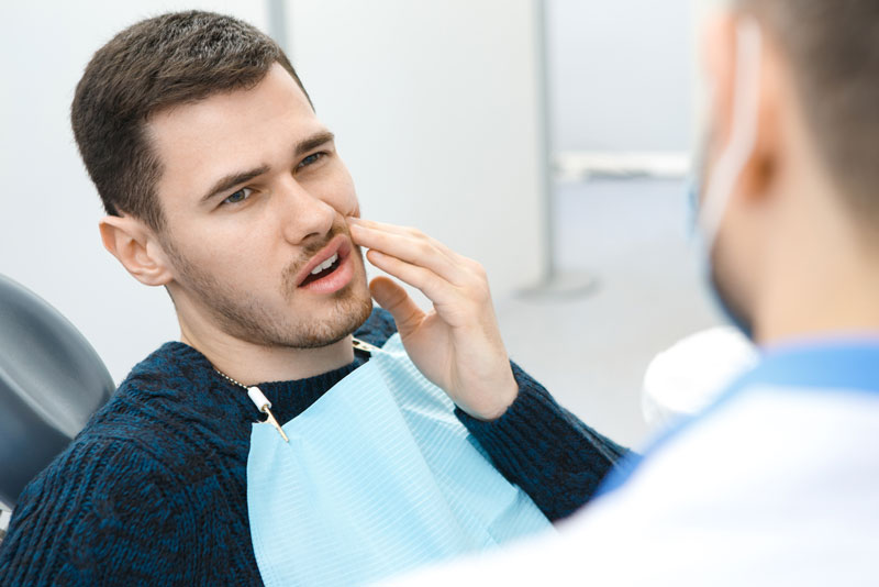 Dental Patient Suffering From Mouth Pain On A Dental Chair, In Springfield, MO