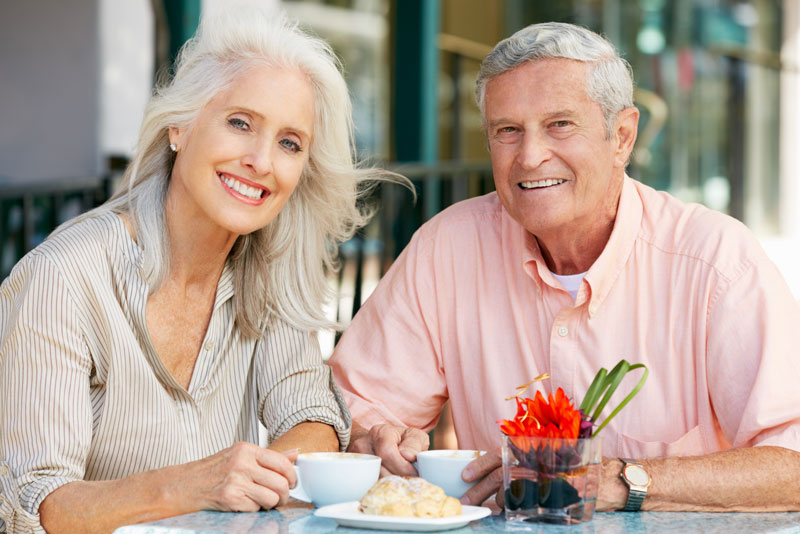 Dental Implant Patients Eating Together With Their False Teeth in Springfield, MO