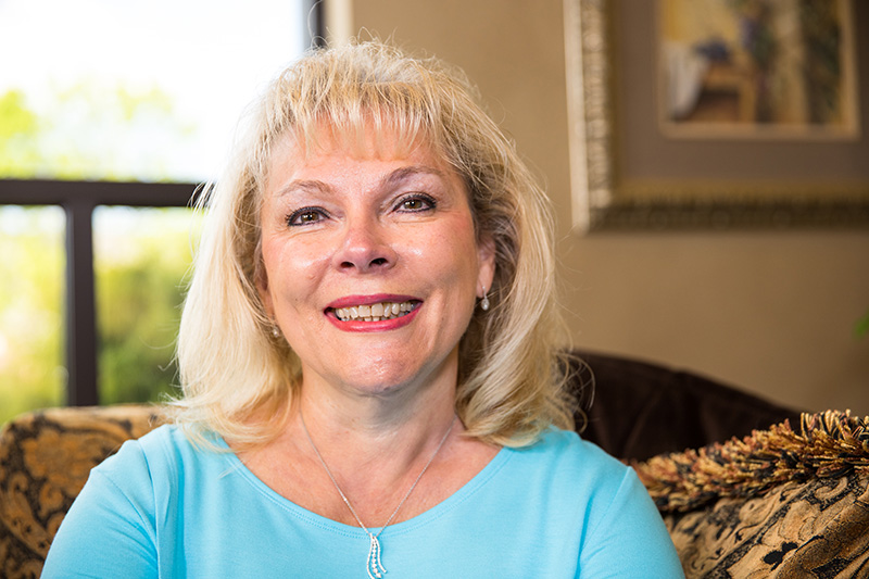 a patient smiling after her dental implants procedure